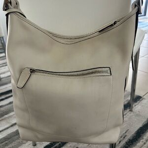 Coach Cream Shoulder Bag with Zip Front Pocket and Tassel. Adjustable strap.